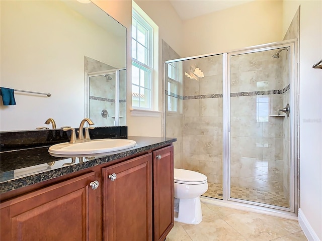 bathroom featuring toilet, tile patterned flooring, plenty of natural light, and vanity