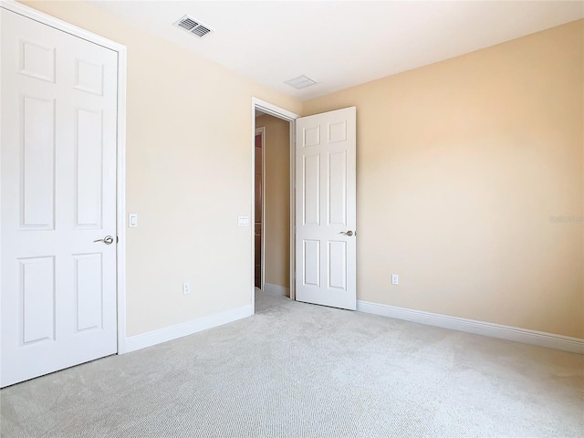 unfurnished bedroom with light carpet