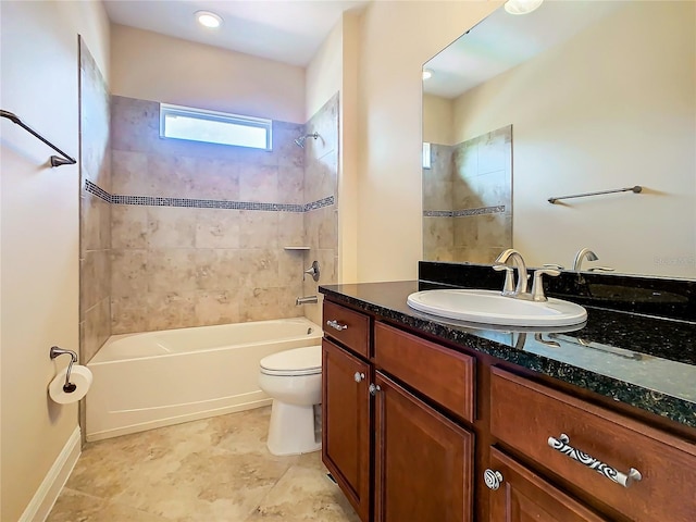 full bathroom with toilet, vanity, and tiled shower / bath