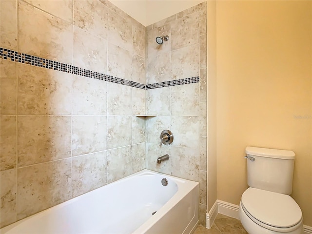 bathroom featuring tile patterned floors, toilet, and tiled shower / bath