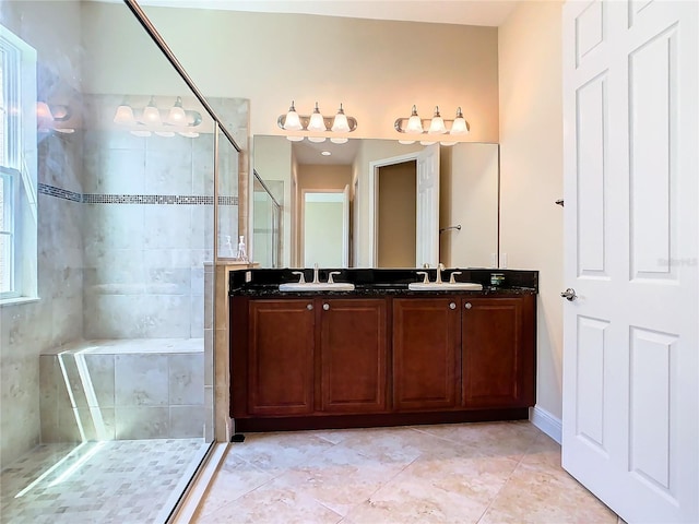 bathroom featuring tile patterned floors, an enclosed shower, and vanity