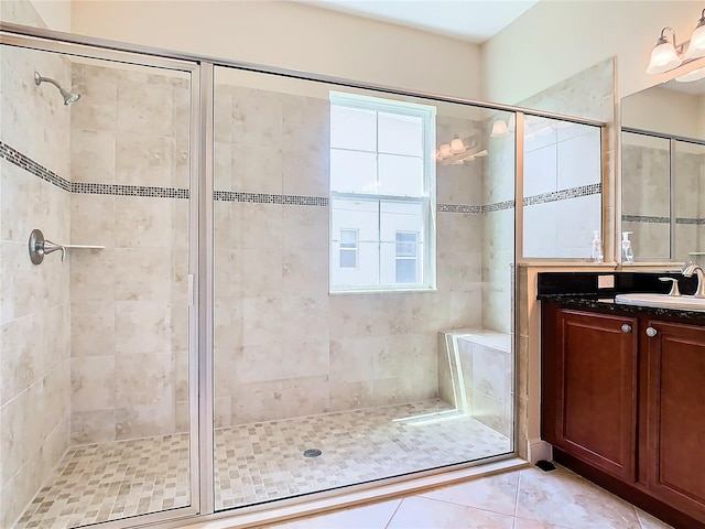 bathroom with tile patterned floors, an enclosed shower, and vanity