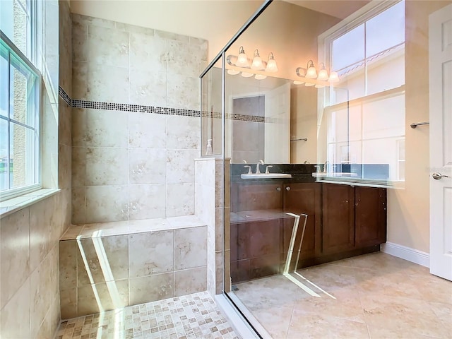 bathroom with vanity and tiled shower