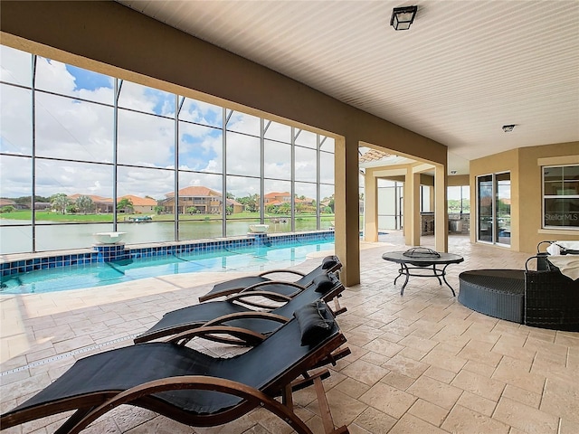 view of patio featuring a water view and a fire pit