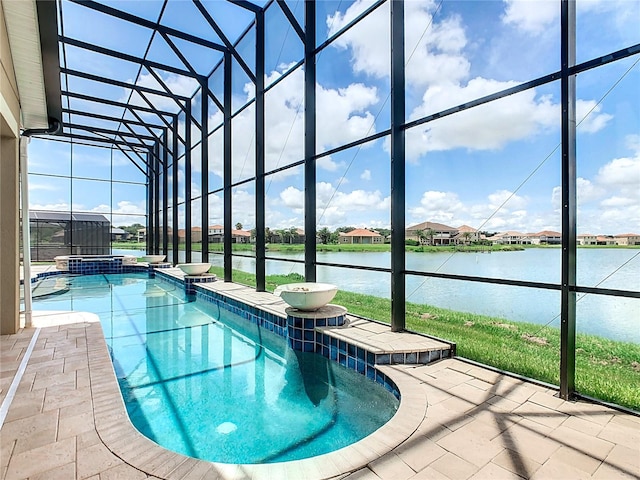 view of swimming pool featuring a lanai and a water view