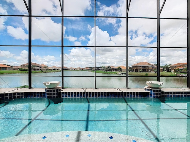 view of swimming pool featuring a water view