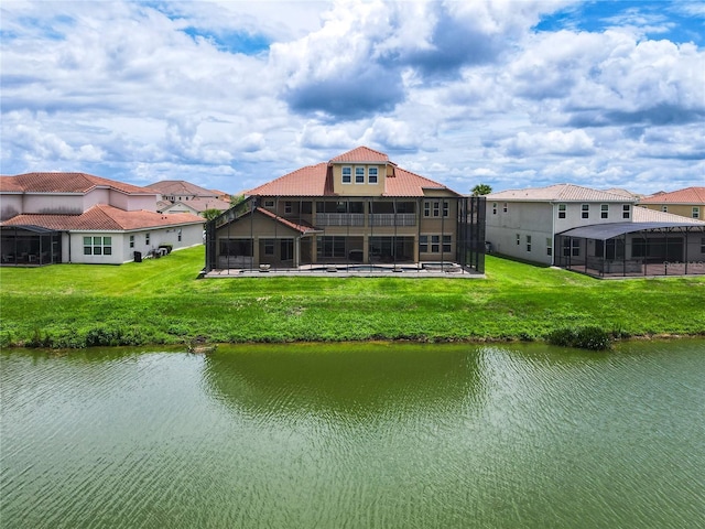 back of house featuring a water view and a yard