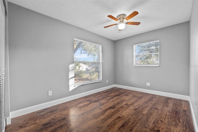 empty room with ceiling fan, wood-type flooring, and a textured ceiling