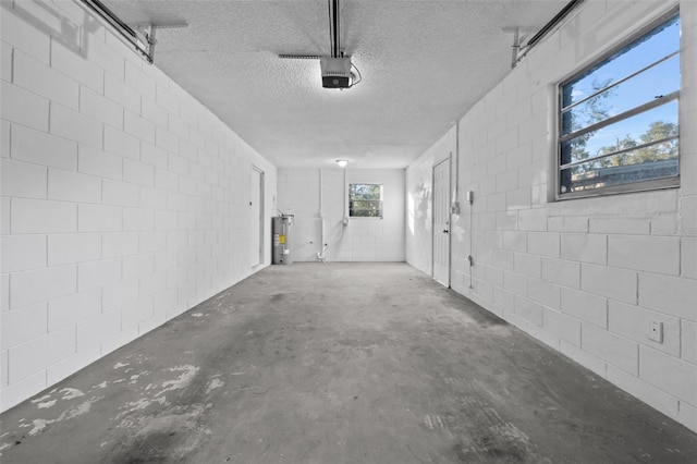 garage featuring electric water heater and a garage door opener