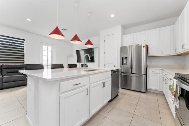 kitchen featuring white cabinetry, sink, pendant lighting, and appliances with stainless steel finishes