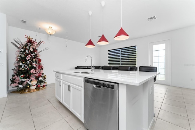 kitchen featuring a center island with sink, sink, stainless steel dishwasher, decorative light fixtures, and white cabinetry