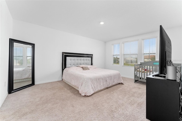 bedroom featuring light carpet