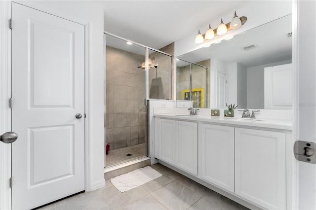 bathroom with tile patterned floors, vanity, and a shower with door