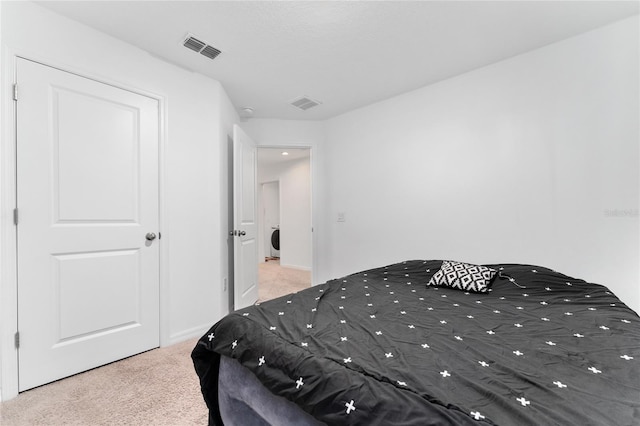 bedroom with washer / dryer and carpet floors