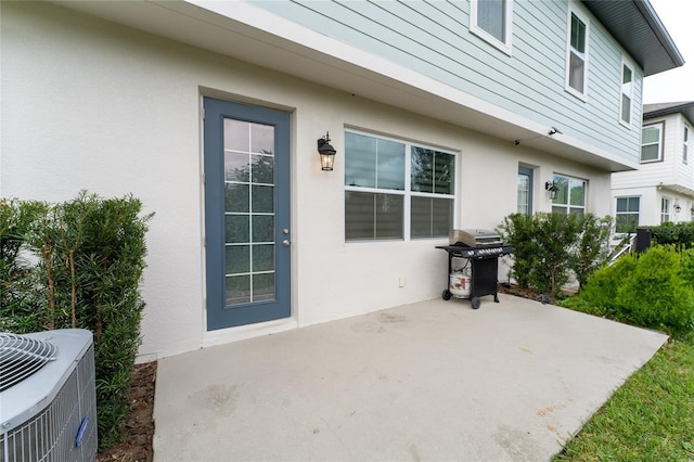 exterior space with central AC and a patio area