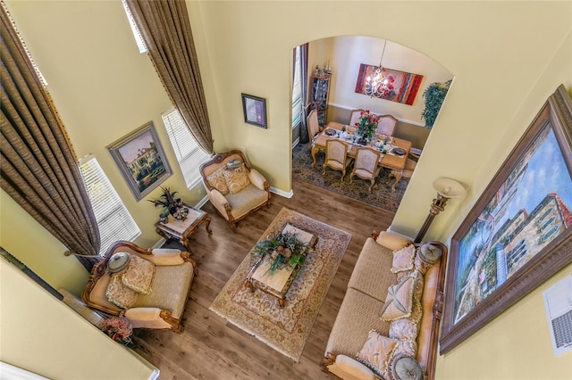 living room with hardwood / wood-style flooring and a chandelier