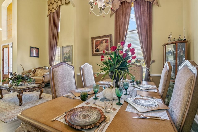 dining area featuring hardwood / wood-style flooring and a chandelier