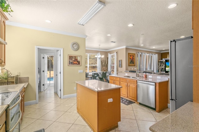 kitchen featuring a kitchen island, appliances with stainless steel finishes, hanging light fixtures, light tile patterned floors, and light stone countertops