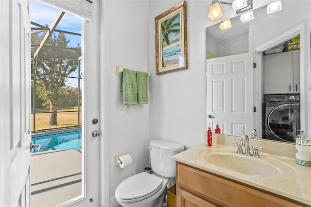 bathroom with vanity, toilet, and washer / clothes dryer