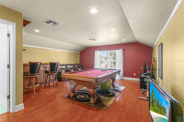 game room with billiards, crown molding, vaulted ceiling, a textured ceiling, and light hardwood / wood-style floors