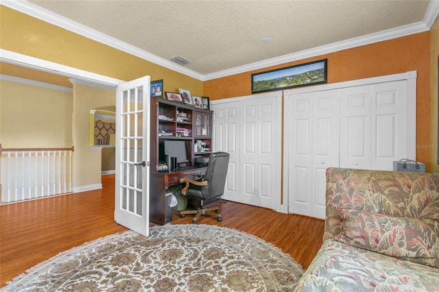 office with crown molding, wood-type flooring, and a textured ceiling