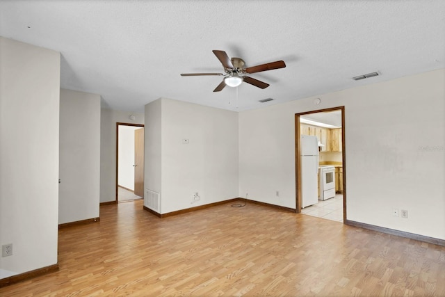 unfurnished room with ceiling fan, a textured ceiling, and light hardwood / wood-style flooring