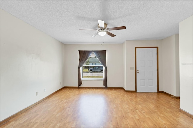 unfurnished room featuring ceiling fan, light hardwood / wood-style flooring, and a textured ceiling