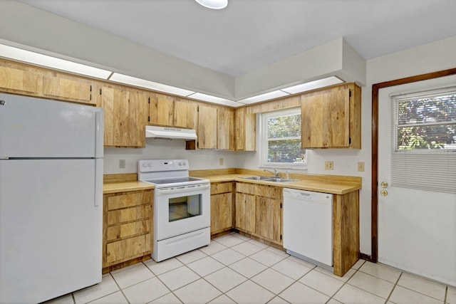 kitchen with sink, white appliances, and light tile patterned flooring