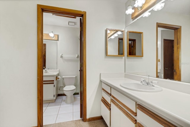 bathroom with vanity, tile patterned floors, and toilet