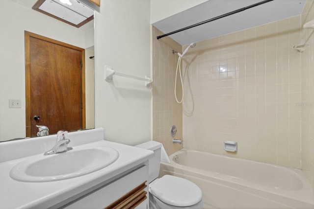 full bathroom with vanity, toilet, and tiled shower / bath