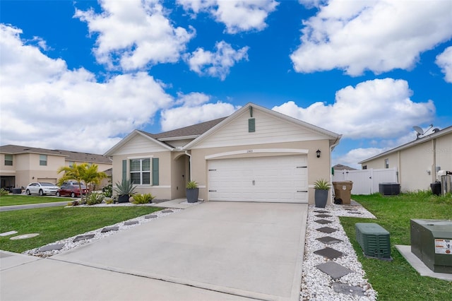 single story home with central AC, a front yard, and a garage