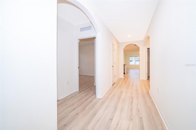 corridor with light hardwood / wood-style floors