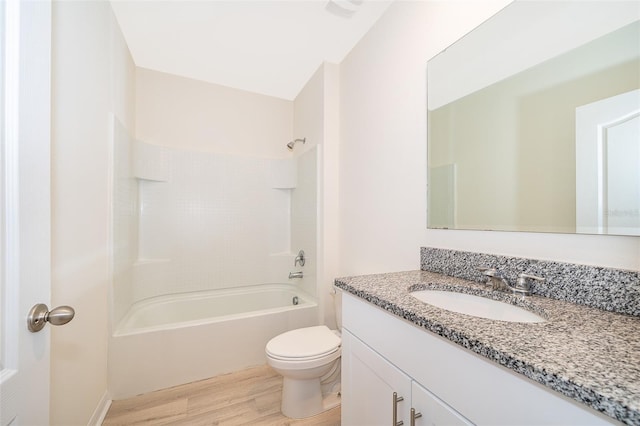 full bathroom featuring toilet, hardwood / wood-style flooring, bathtub / shower combination, and vanity