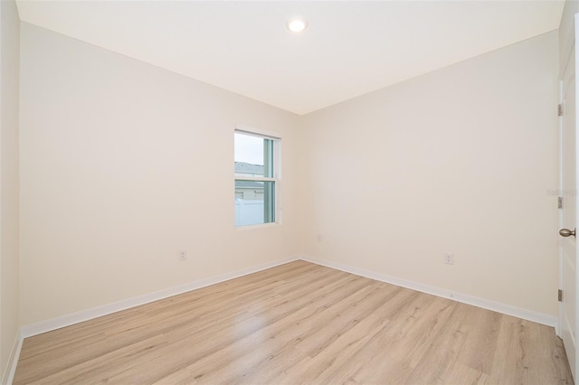 spare room with light hardwood / wood-style floors