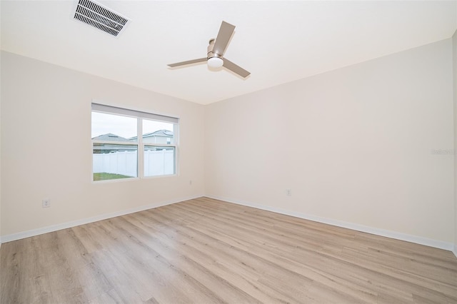 empty room featuring light wood-type flooring and ceiling fan