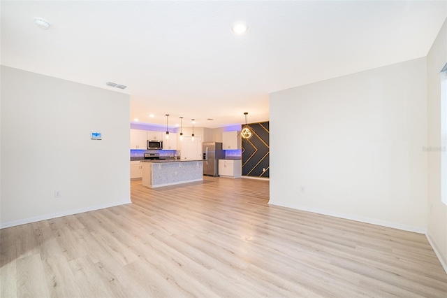 unfurnished living room with light wood-type flooring