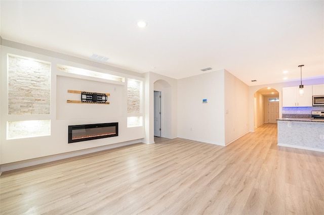 unfurnished living room with light wood-type flooring