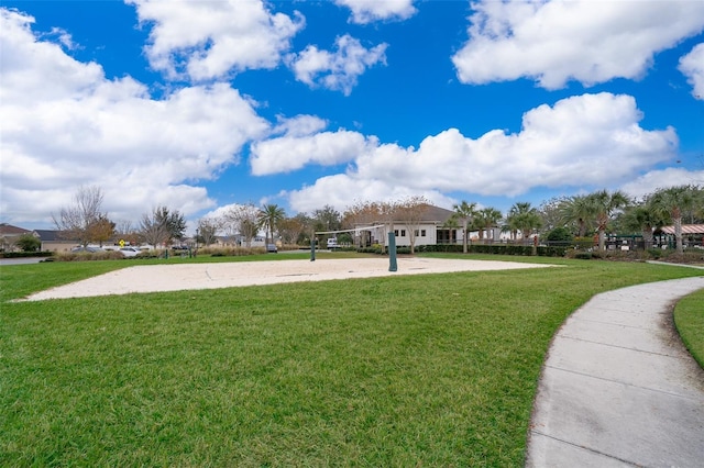 view of community with volleyball court and a yard