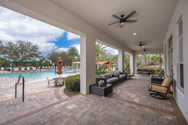 view of patio featuring a community pool, ceiling fan, and an outdoor living space