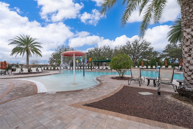 view of pool with pool water feature and a patio