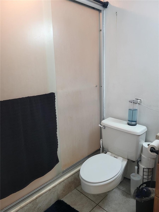 bathroom featuring tile patterned floors and toilet