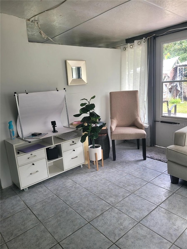 sitting room with tile patterned floors