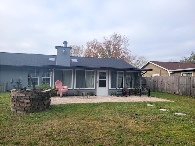 rear view of house with a patio, a yard, and cooling unit