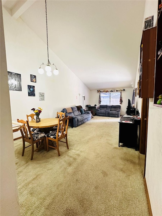 carpeted dining space with beam ceiling and high vaulted ceiling