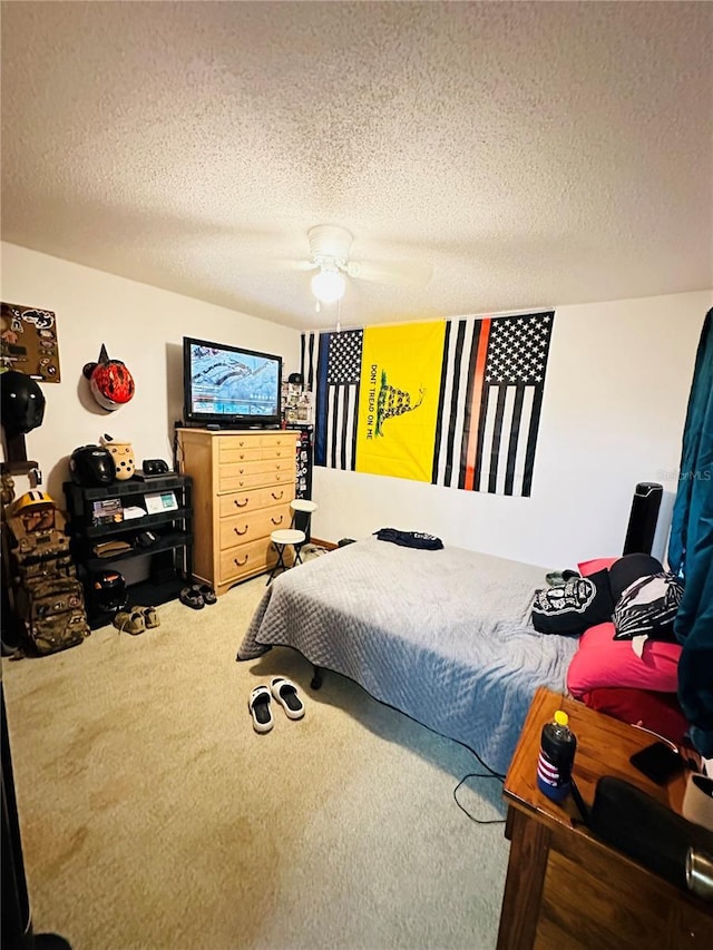 carpeted bedroom with a textured ceiling and ceiling fan