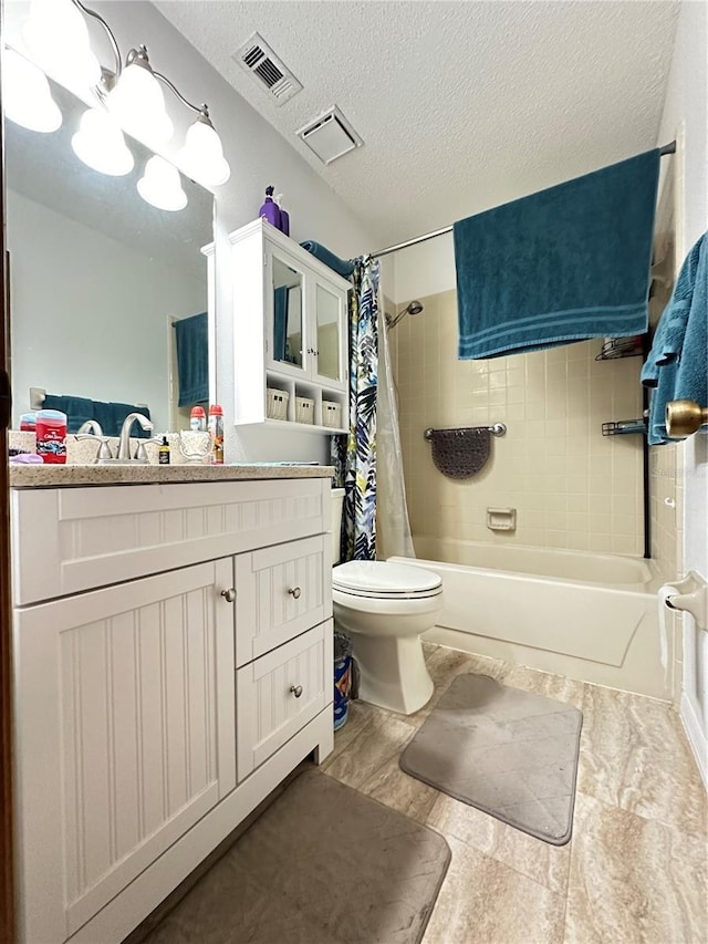 full bathroom with a textured ceiling, toilet, vanity, and shower / bath combo with shower curtain