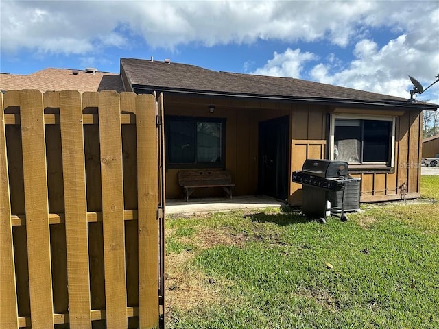 rear view of property with a lawn