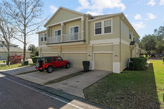 view of property with a garage and a front lawn