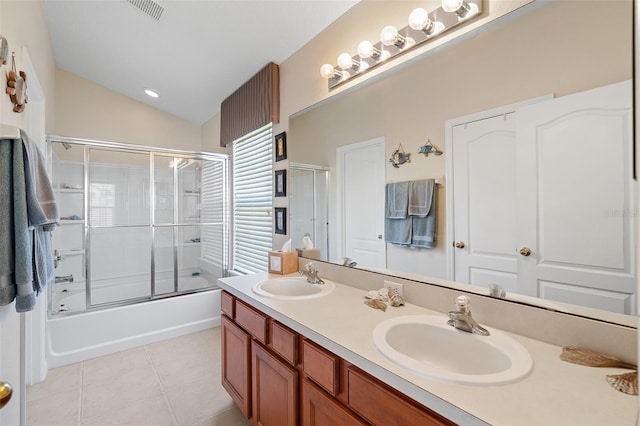 bathroom with tile patterned flooring, vanity, combined bath / shower with glass door, and vaulted ceiling