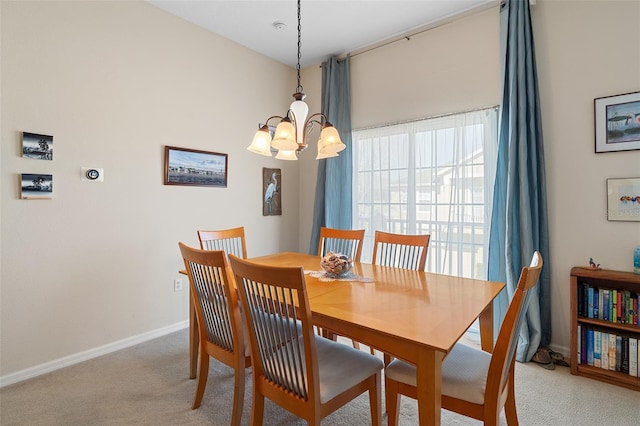 carpeted dining space featuring an inviting chandelier